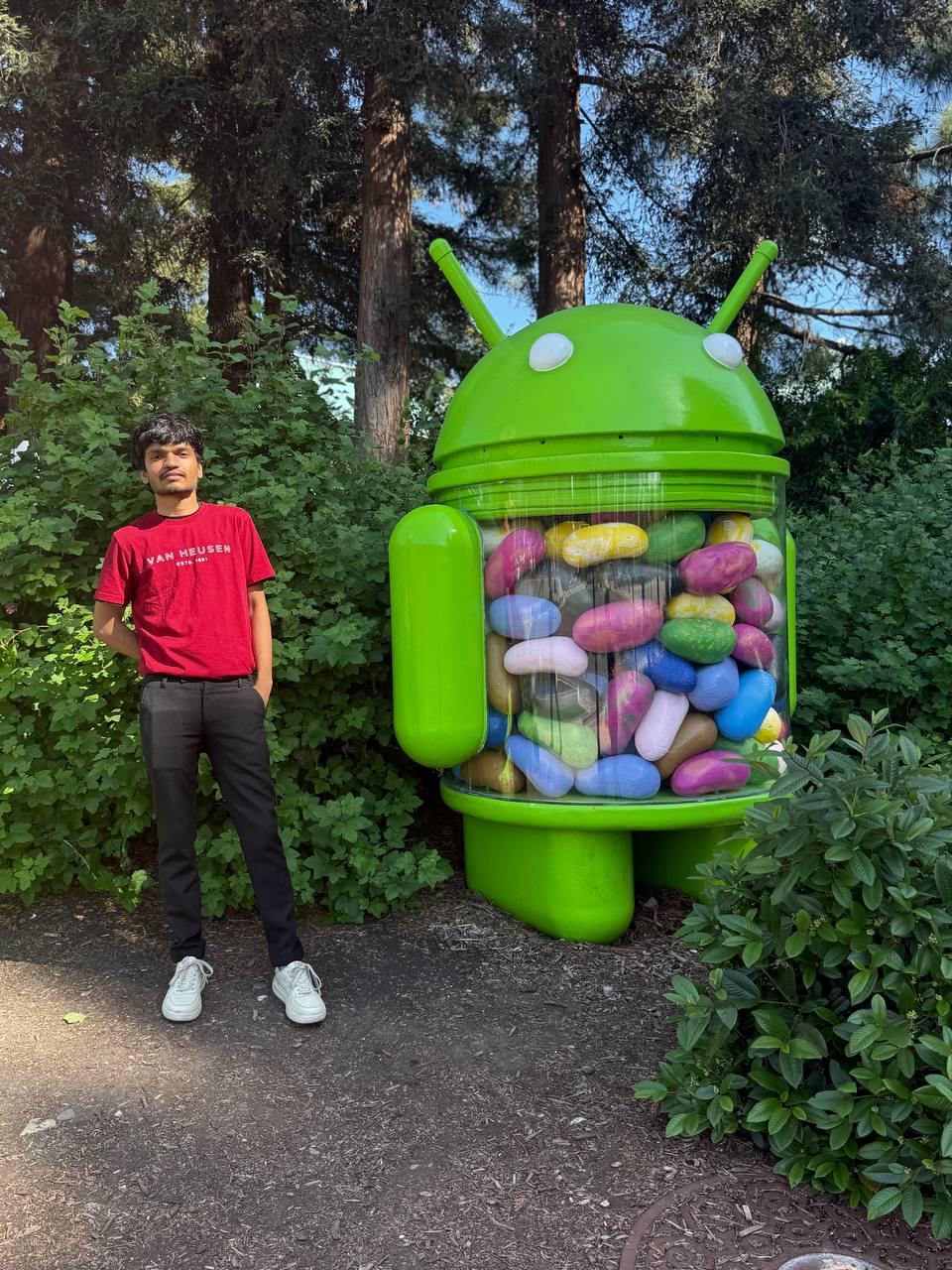 Khush Patel beside the Android Jelly Bean statue on the Google campus