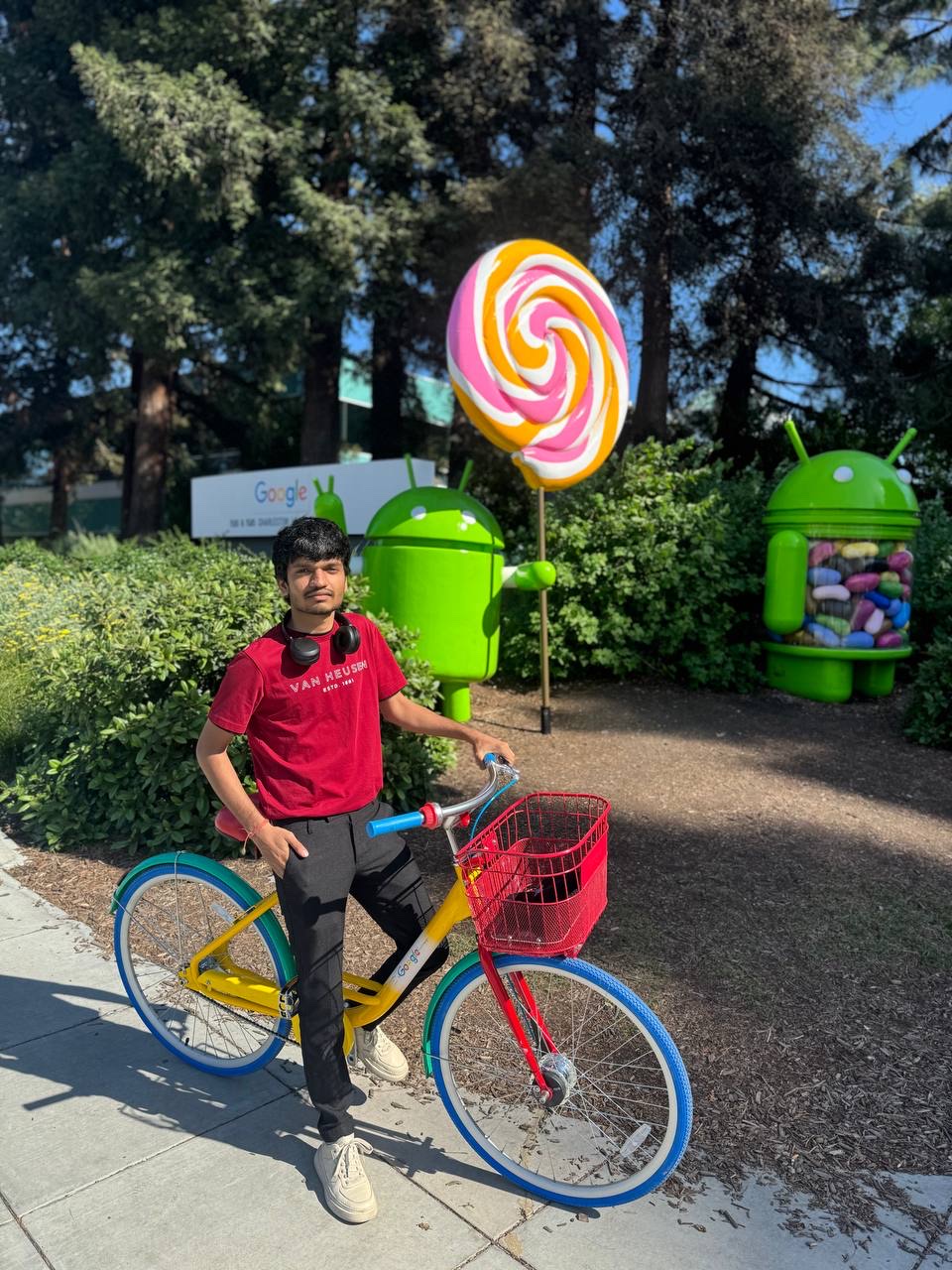 Khush Patel on a Google bike at the Android statue garden, Google campus, Mountain View